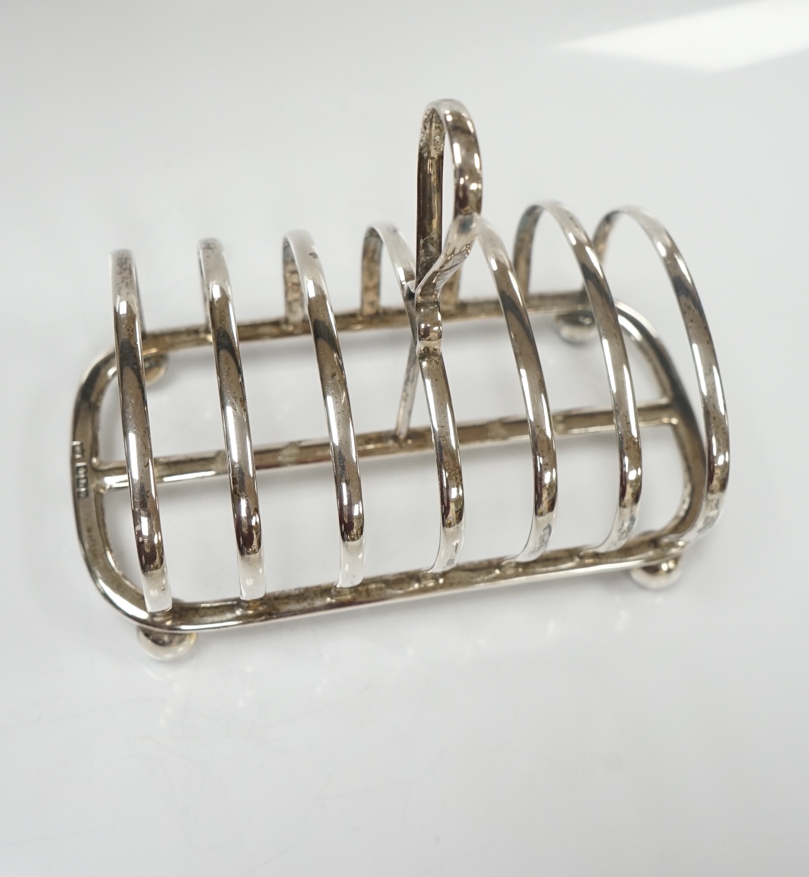 A George V silver seven bar toast rack, by Mappin & Webb, Sheffield, 1913, length 15cm, 7.3oz. Condition - fair to good